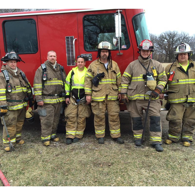 firefighters standing by fire truck