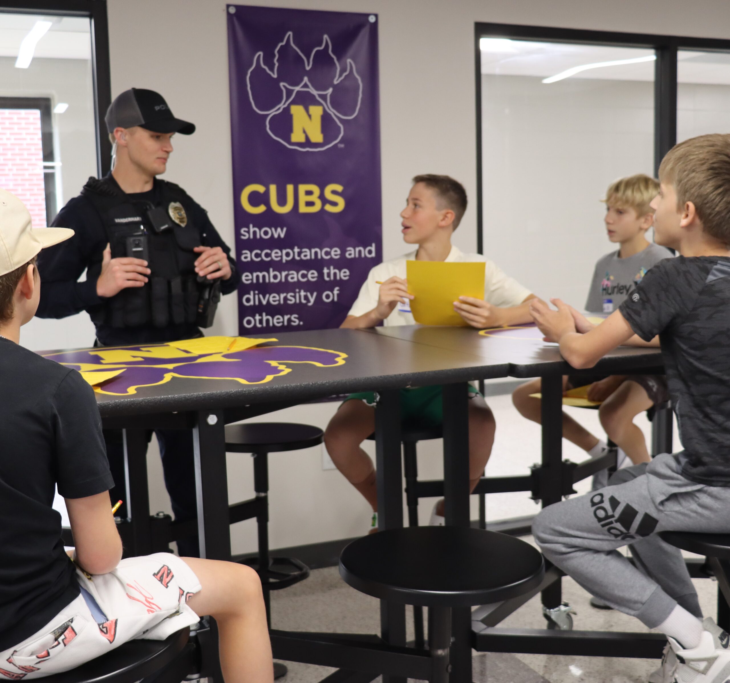 SRO Lane VanderHart is pictured with several middle school students at the middle school