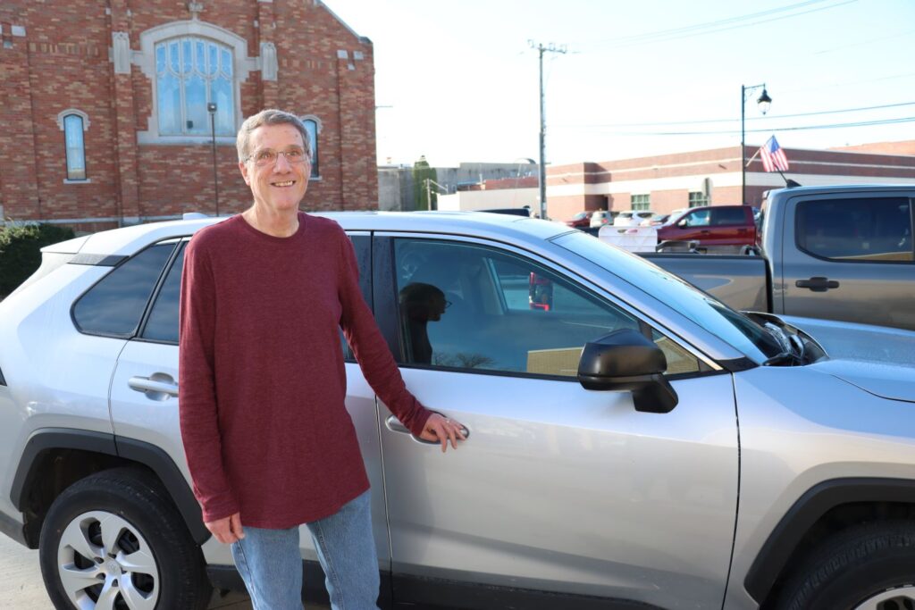 Jeff Sodt stands next to his car.