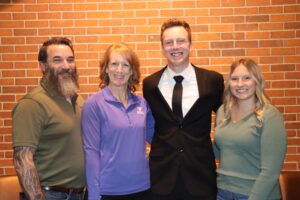 New Police Officer Carter Morphew is pictured with his parents and girlfriend.