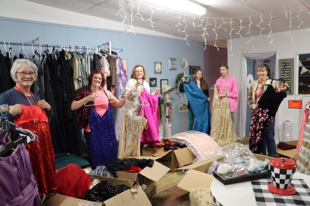 Sorting through new formal dresses received at Harmony Closet’s Prom Dress Exchange from Something Blue are (from left) Linda Zaletel, Anne Zaletel, Elizabeth Gindt, Giada Colbeck, Ava Vanderhayden, and Sarah Gilchrist.