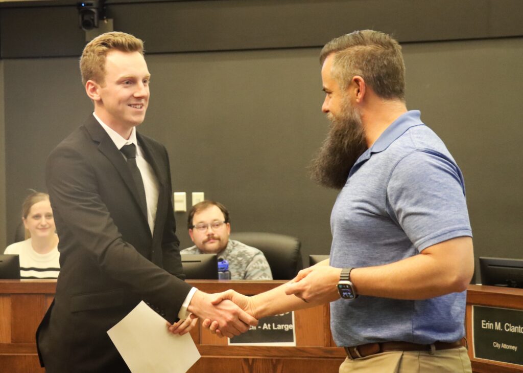 Carter Morphew shakes the hand of Mayor Brett Barker.