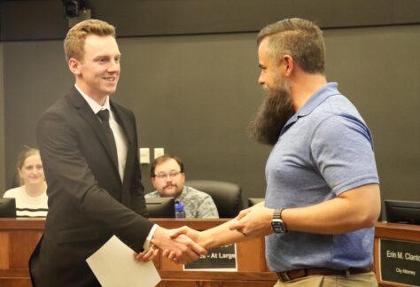 Carter Morphew shakes the hand of Mayor Brett Barker.