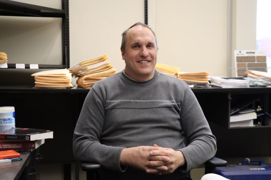 Mike Sauer sits in the P and Z office at his desk