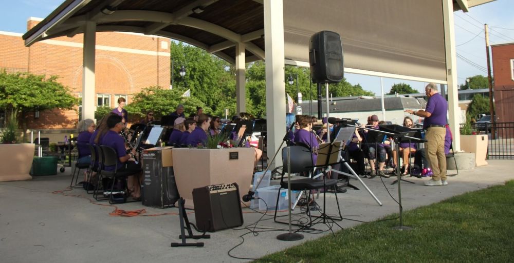The Nevada Community Band is pictured under the bandshell in front of City Hall during one of its summer concerts.