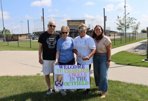 Shown are (from left) Reed and Lynn-Marr Moore, Parks and Rec Director Rhonda Maier, and Kelsey White, Executive Director of the Cystic Fibrosis Foundation, Iowa Chapter, all standing in front of the Nevada High School baseball field at SCORE.