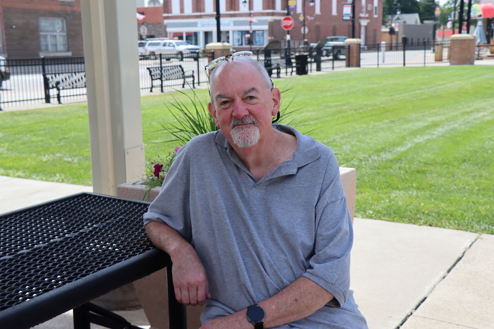 Bill Negus pictured at a picnic table.