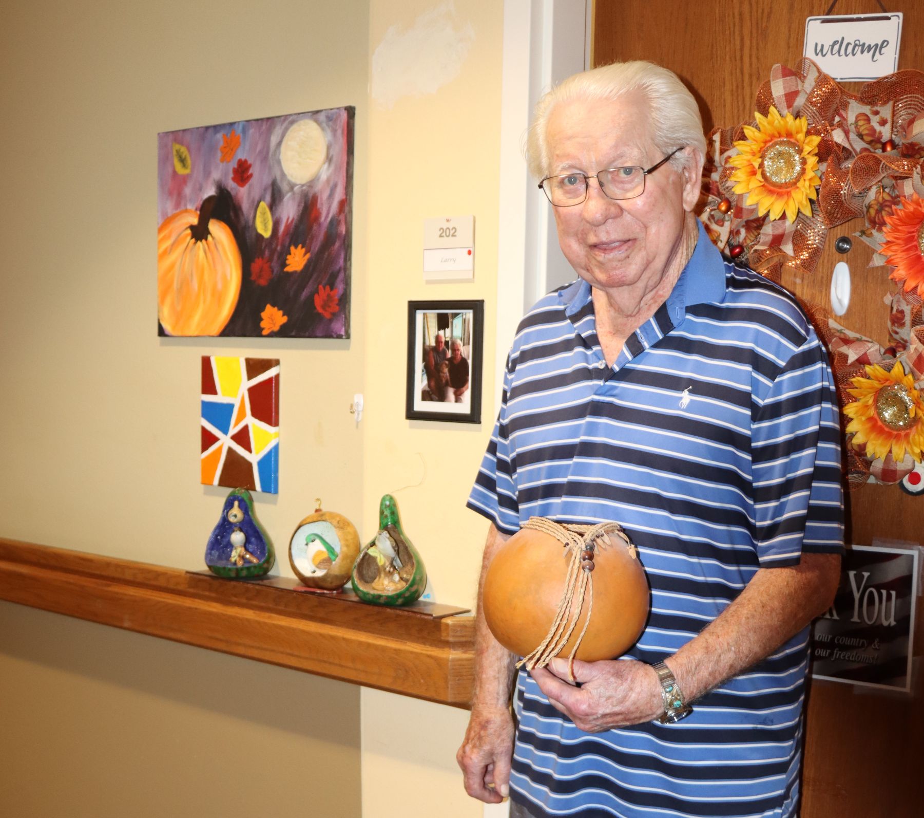 Artist Larry Reinig shows off some of his gourd art pieces.